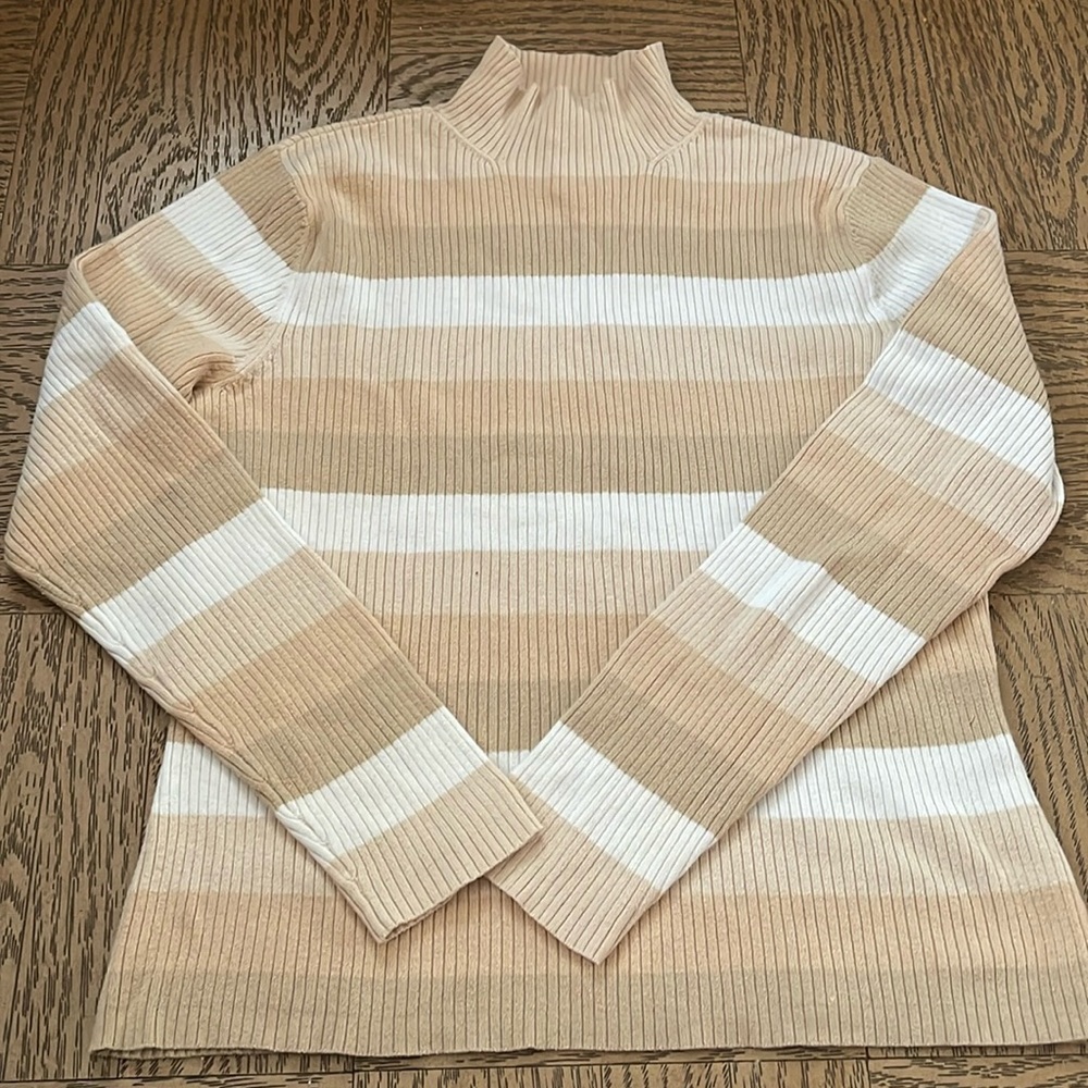 A beige color turtle neck, perfect for the fall. Size S